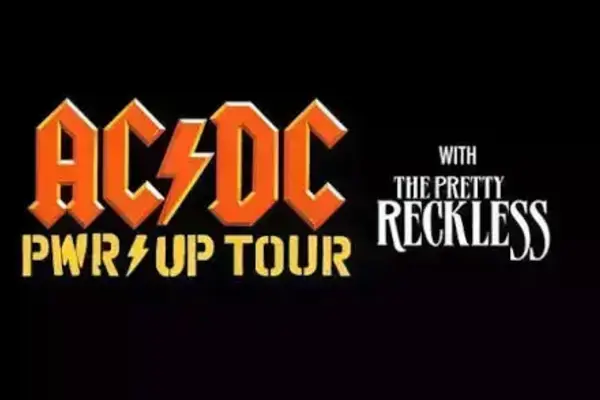 AC/DC PWR/UP TOUR in orange letters with a lightning bolt slash, and With The Pretty Reckless in white text.